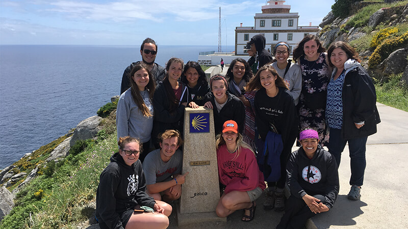 Students posing by monument on education abroad trip