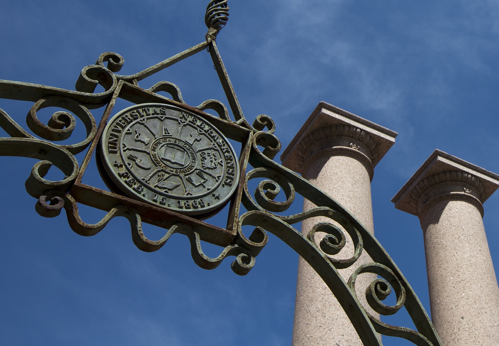 Iron arch with seal on campus