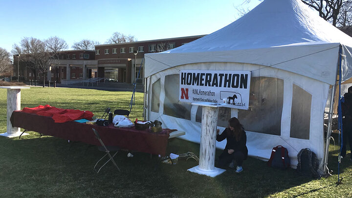 Tent outside of the union with a sign that reads "Homerathon"