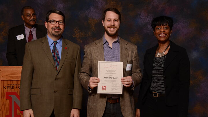 Yaroslav Komarovski and Matthew Loar with Joseph Francisco and a member of university administration